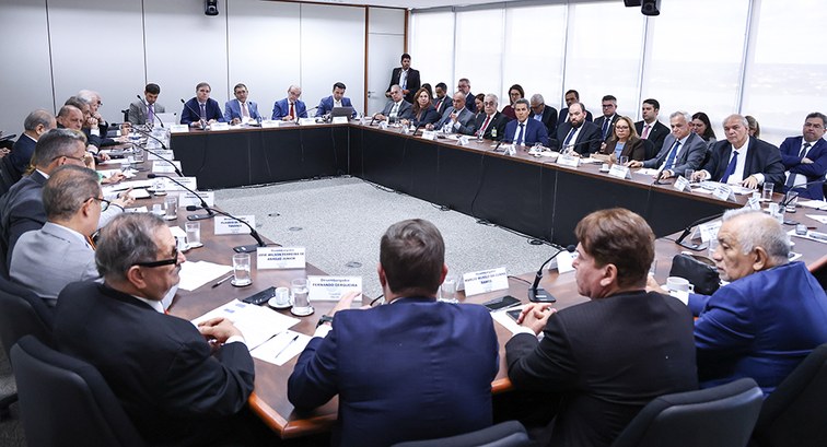 Fotografia de uma reunião formal com presidentes de Cortes Eleitorais em trajes sociais, sentado...